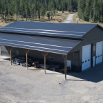 A charcoal post-frame agriculture storage building with wainscoting and overhead doors