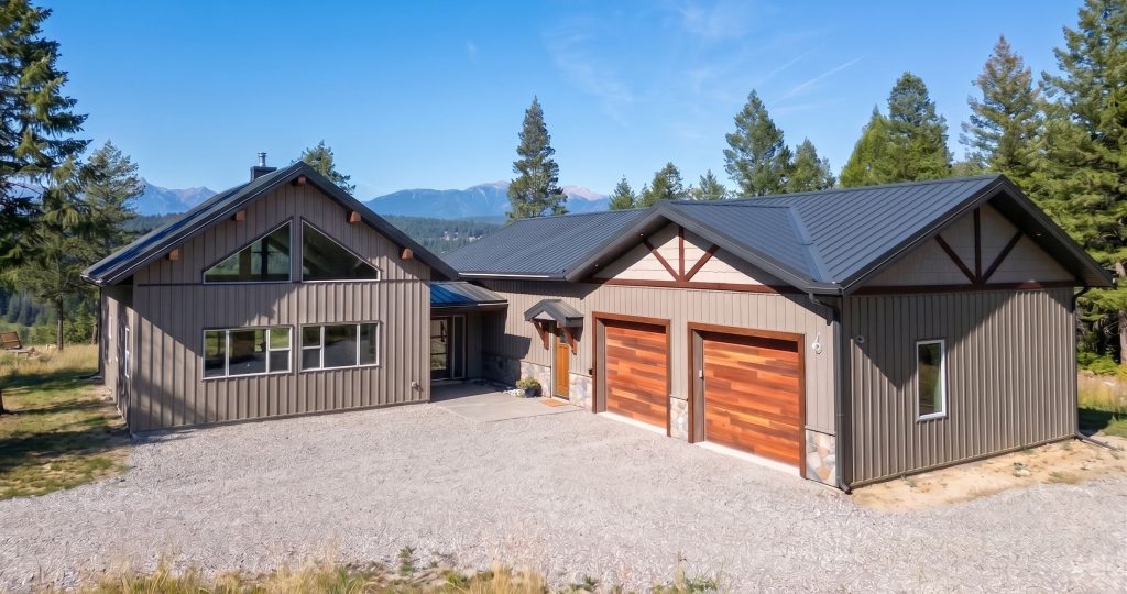 A custom residential post-frame home with soffits, and overhead doors