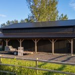 A dark brown lifestyle shop with an open lean-to and awnings