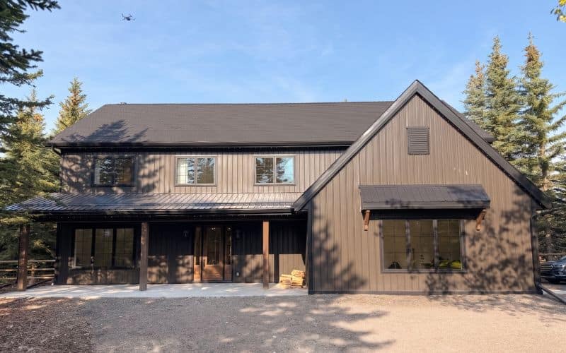 A dark brown custom post-frame residential home