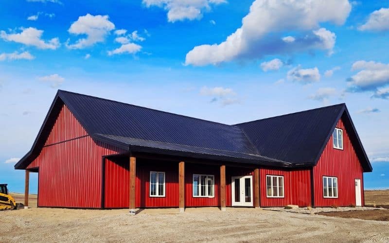 A dark red post-frame residential Highwood with Loft