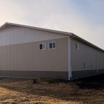 A wicker machine shed with buckskin wainscoting and overhead doors