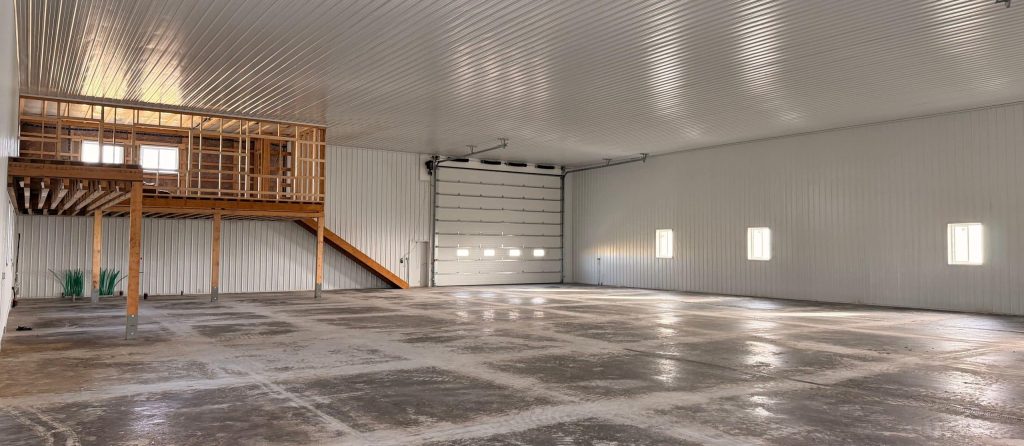 A wicker machine shed with buckskin wainscoting and overhead doors