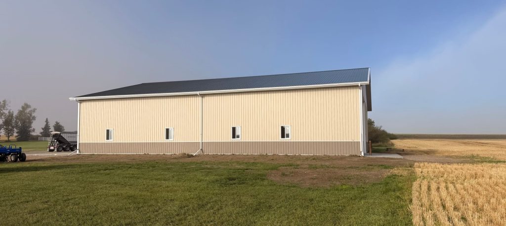 A wicker machine shed with buckskin wainscoting and overhead doors