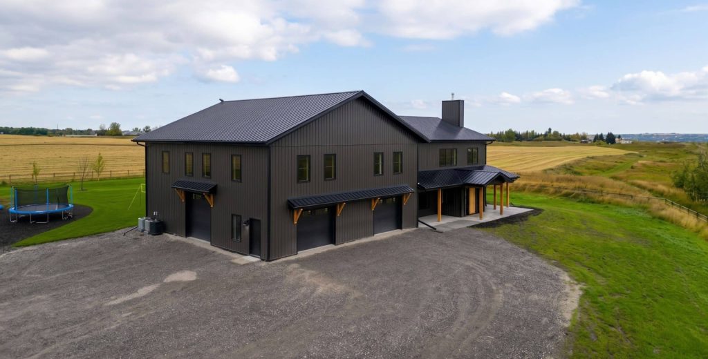 A post-frame custom home with a front porch, timber accents, and an attached garage