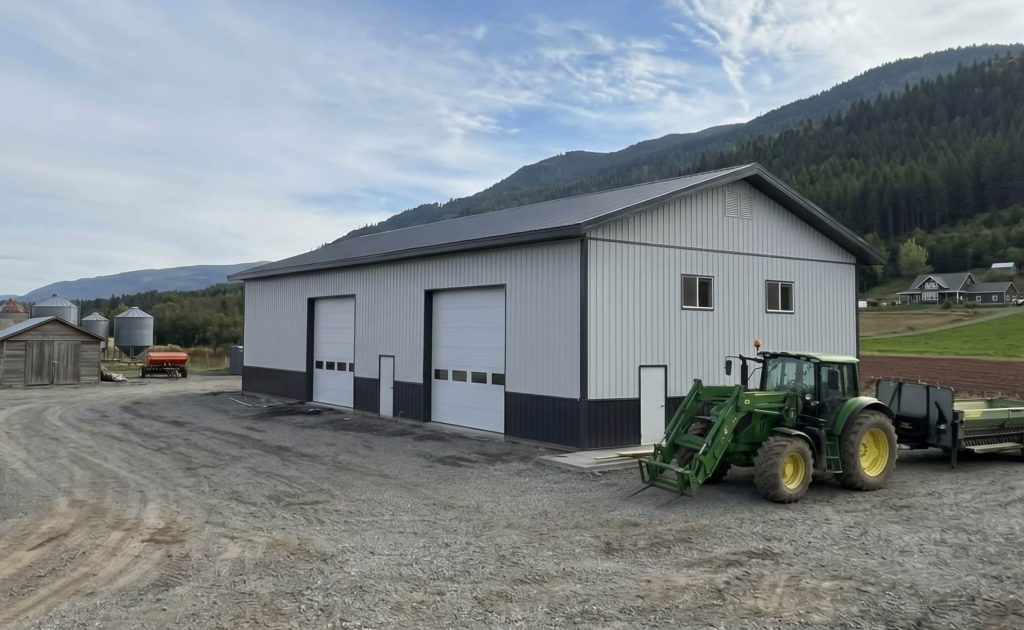 A white white post-frame agriculture storage building with wainscoting