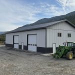 A white white post-frame agriculture storage building with wainscoting